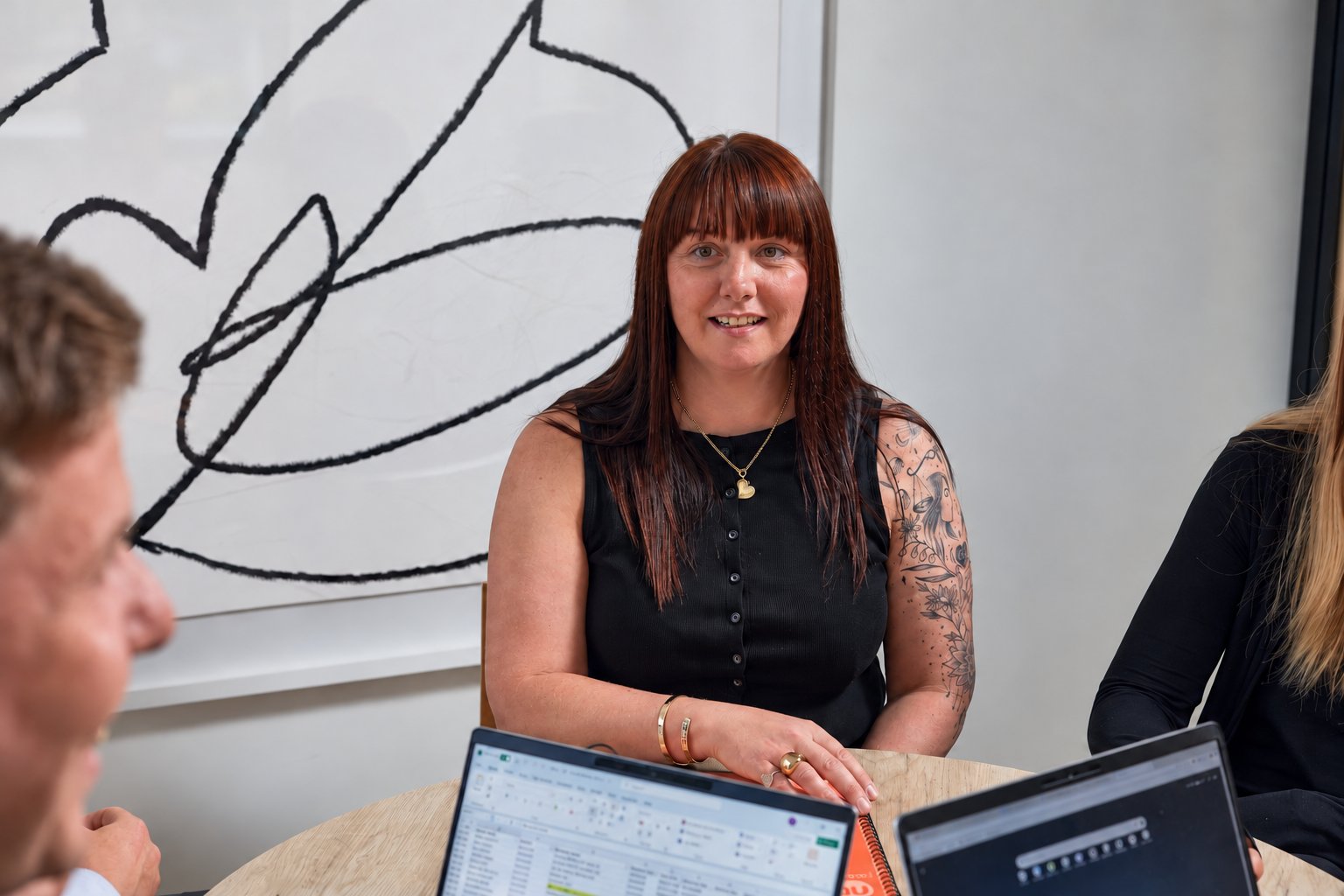 Clair in a meeting with the team